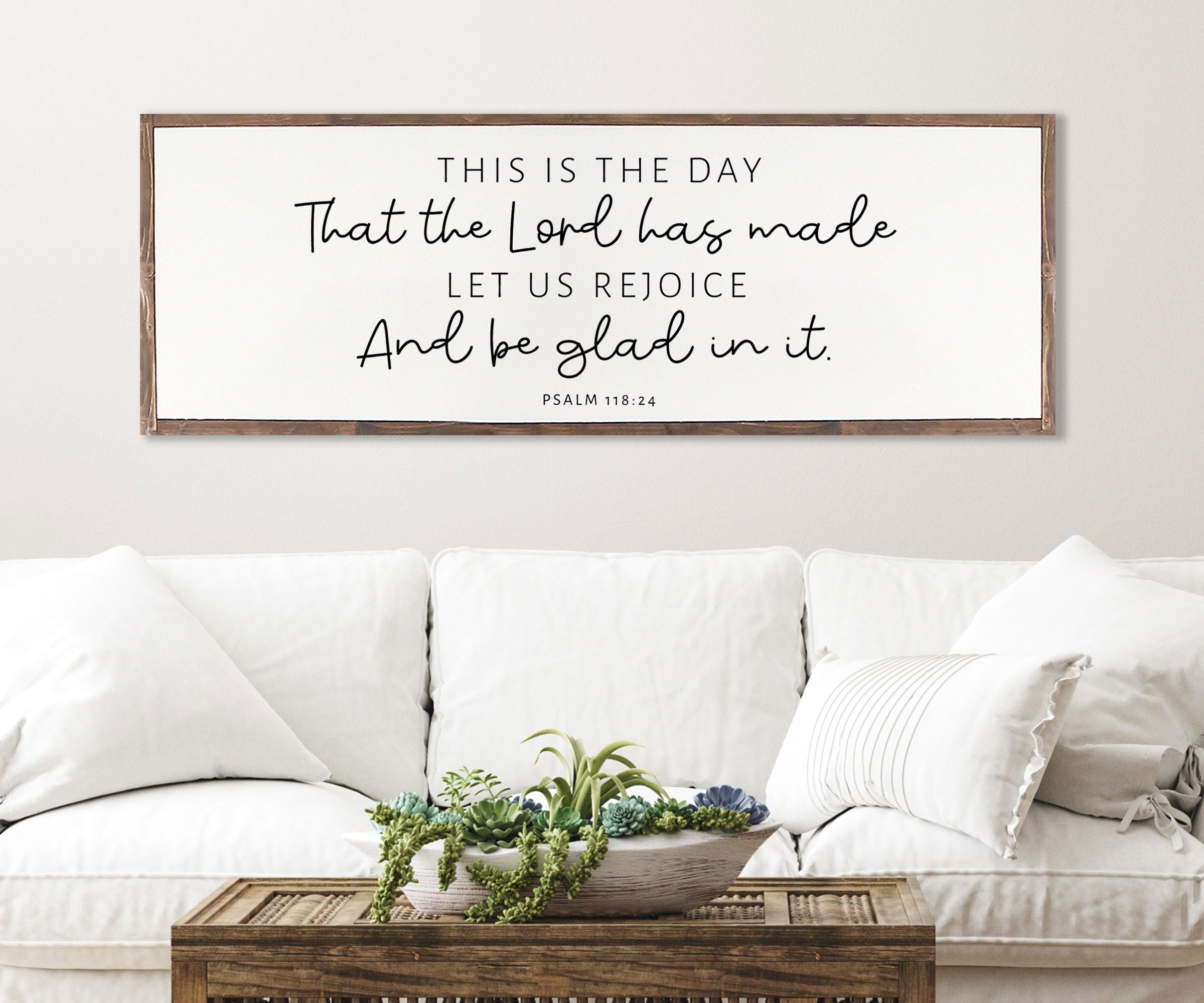Rustic wood sign featuring the quote 'This Is The Day That The Lord Has Made' from Psalm 118:24, framed in a customizable stain color.