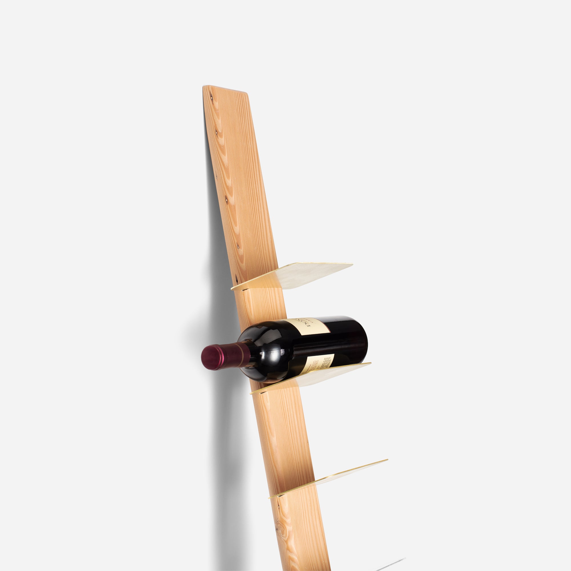 Stylish TIPsy wine rack displaying wine bottles, crafted from repurposed wood with brushed brass accents.