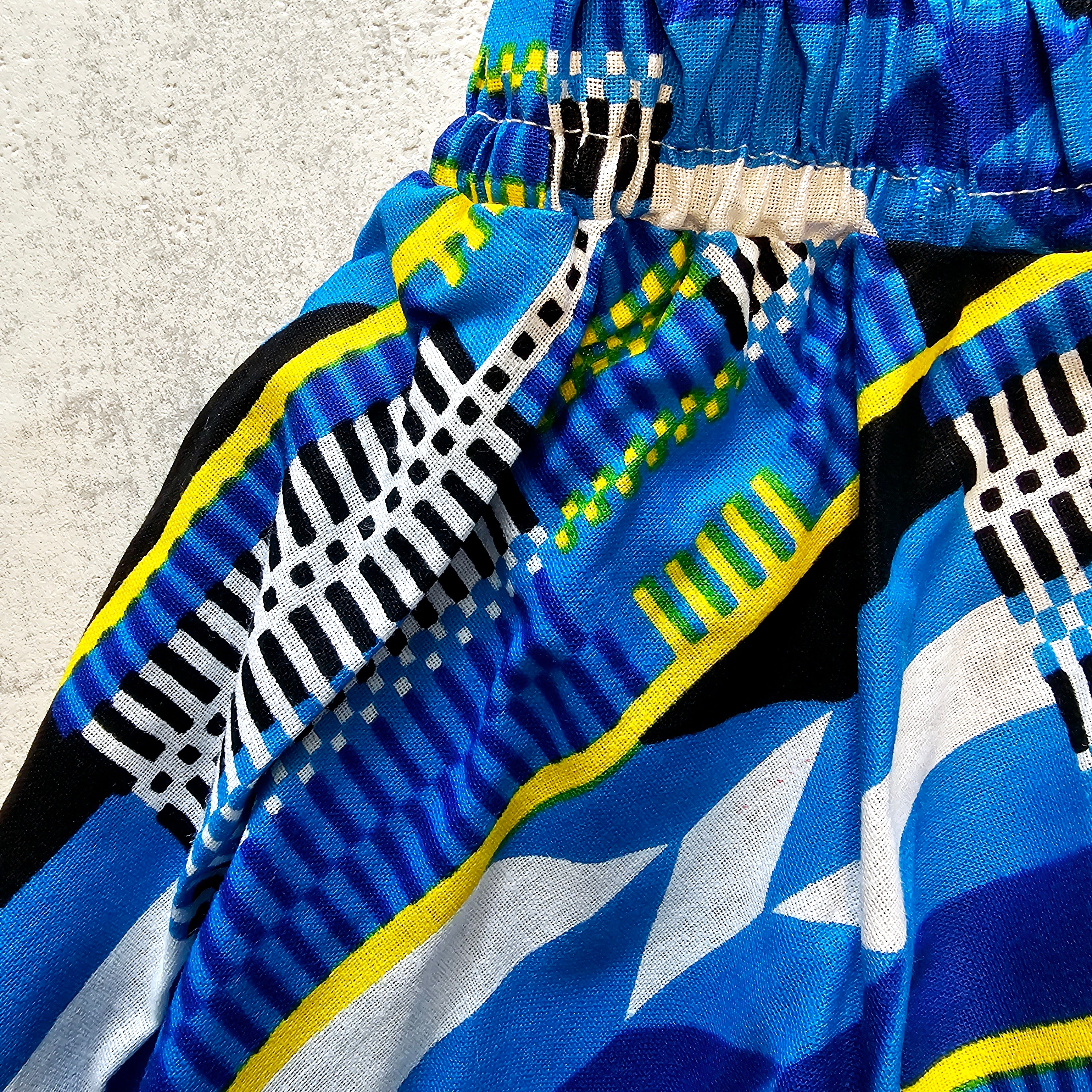 A vibrant Toddler Circle Skirt made from Ankara fabric, featuring a colorful design and an elastic waist, perfect for playful little girls.