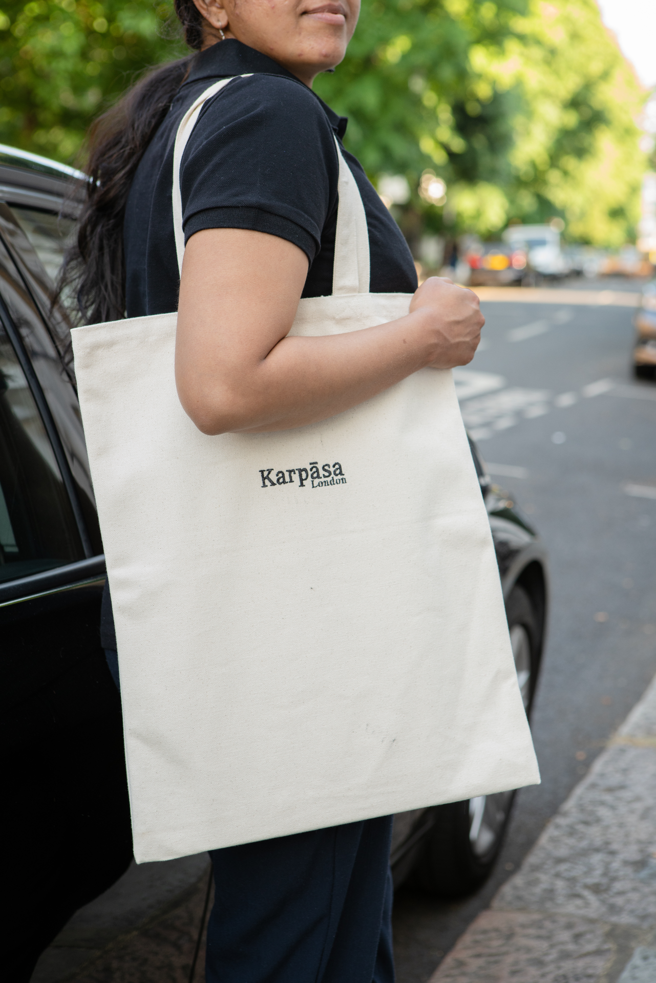 A natural-colored organic cotton tote bag made from 100% GOTS certified fabric, showcasing its sturdy handles and spacious design.