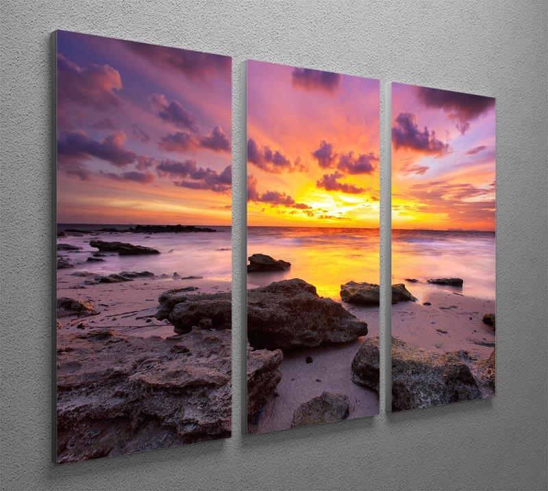 A stunning 3-panel canvas print depicting a tropical beach at sunset, showcasing vibrant colors and serene scenery.