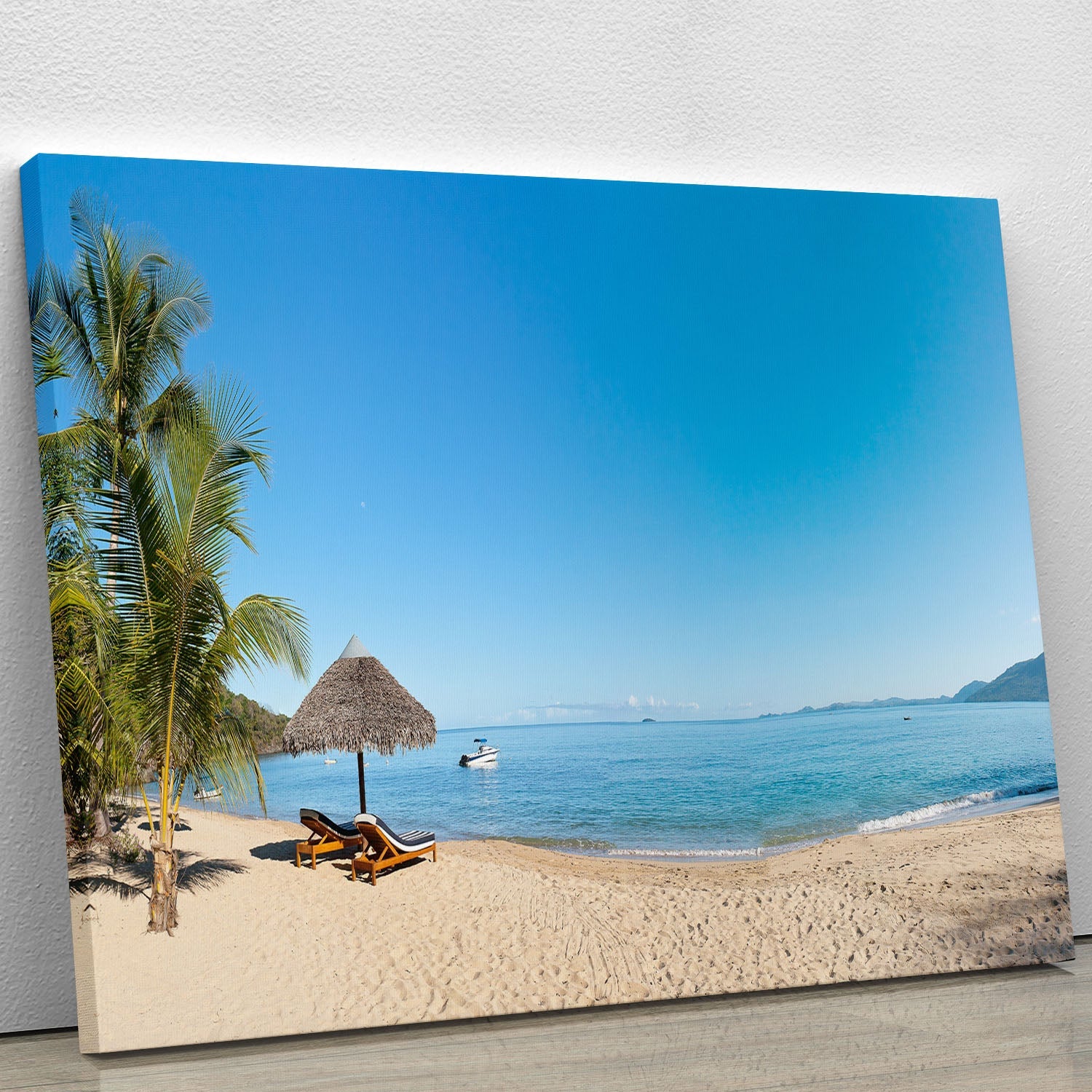 A vibrant canvas print of a tropical beach panorama featuring deckchairs under a clear blue sky, perfect for home decor.