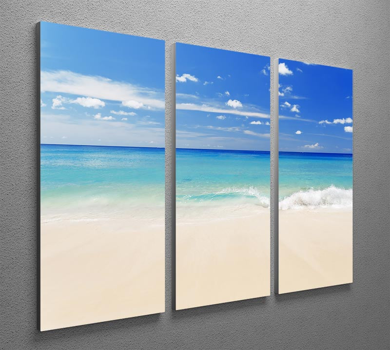 A beautiful 3-panel canvas print depicting a tropical white sand beach under a clear blue sky, perfect for home decor.