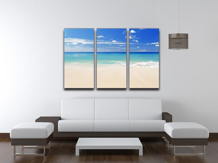 A beautiful 3-panel canvas print depicting a tropical white sand beach under a clear blue sky, perfect for home decor.