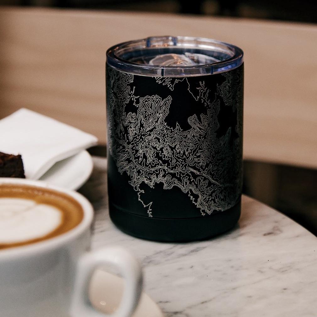 Matte black insulated cup featuring a custom engraved map of Tucson, Arizona with coordinates.
