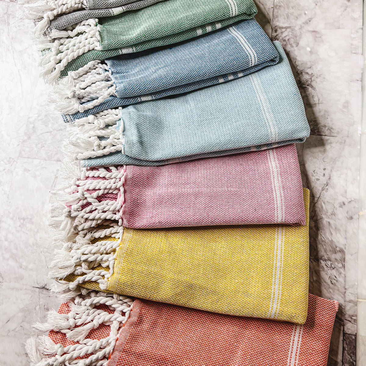 Luxurious oversized Turkish hand towel with bamboo tassels, showcasing vibrant colors and elegant design.