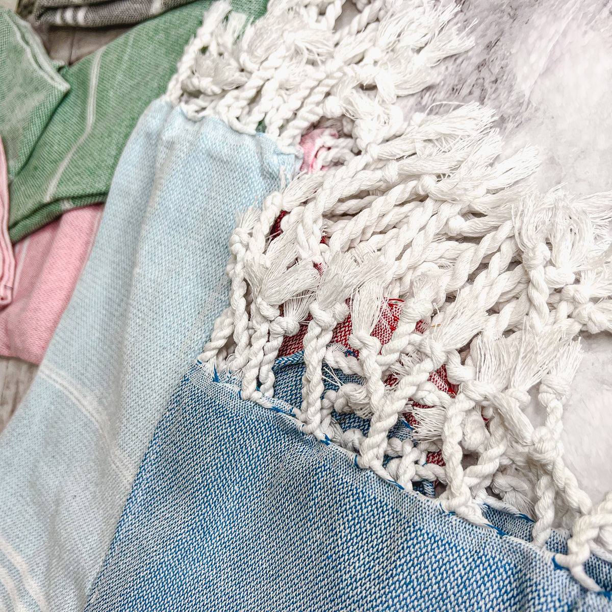 Luxurious oversized Turkish hand towel with bamboo tassels, showcasing vibrant colors and elegant design.