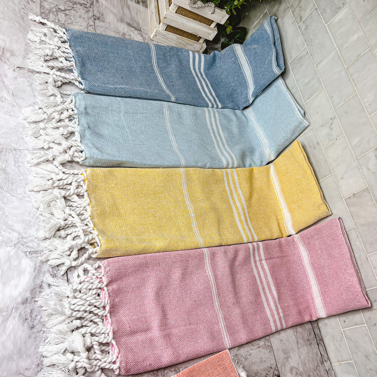 Luxurious oversized Turkish hand towel with bamboo tassels, showcasing vibrant colors and elegant design.