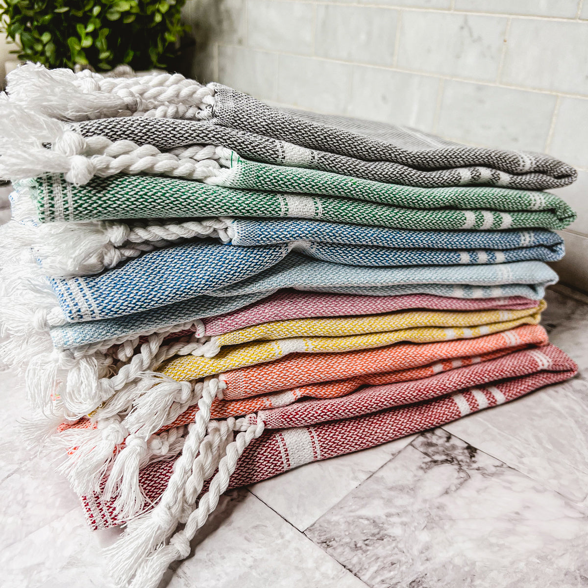 Luxurious oversized Turkish hand towel with bamboo tassels, showcasing vibrant colors and elegant design.