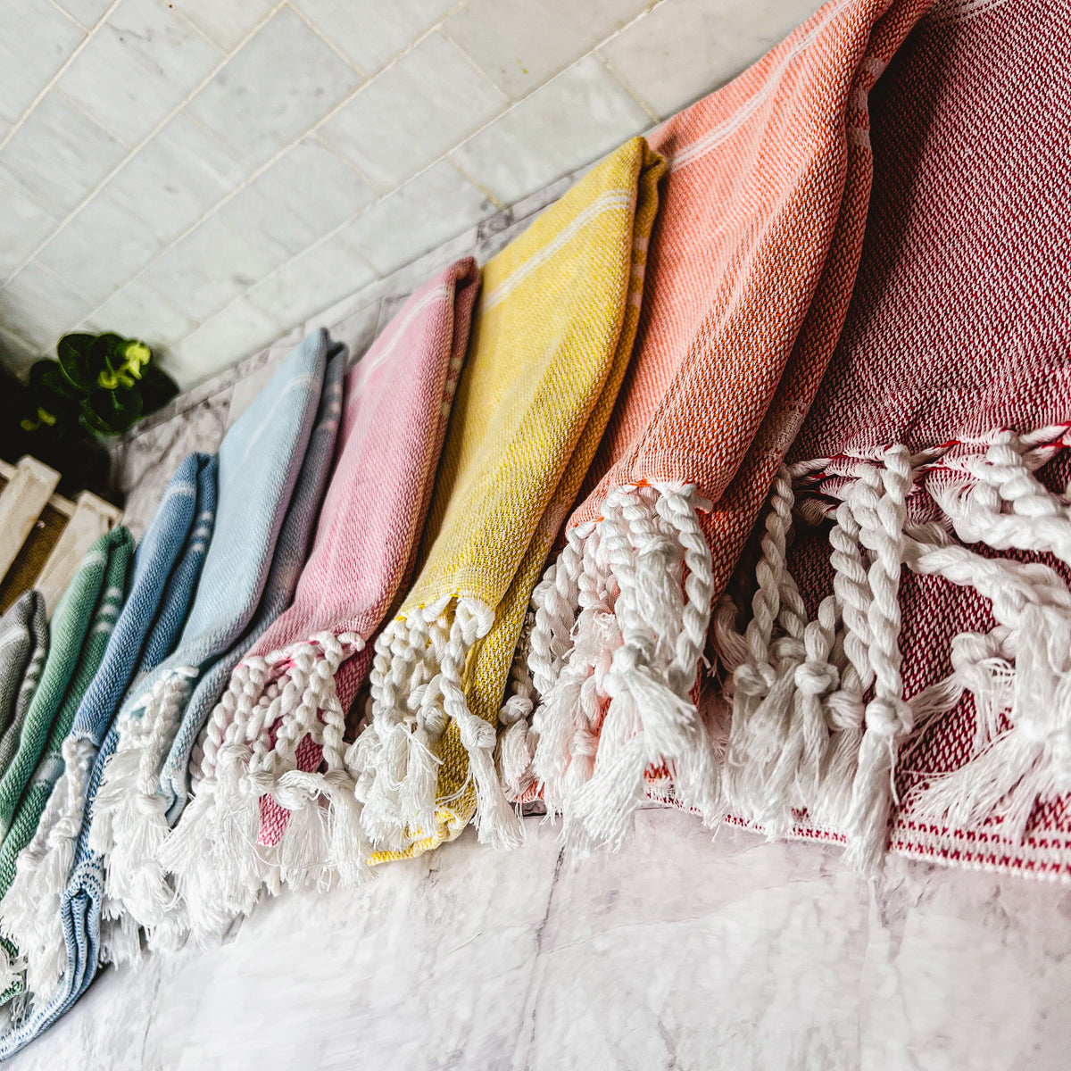 Luxurious oversized Turkish hand towel with bamboo tassels, showcasing vibrant colors and elegant design.