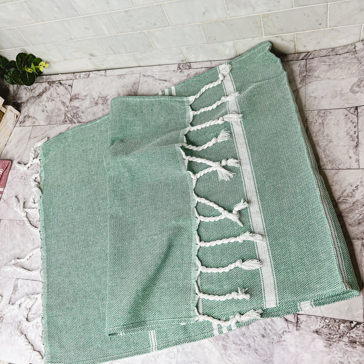 Luxurious oversized Turkish hand towel with bamboo tassels, showcasing vibrant colors and elegant design.