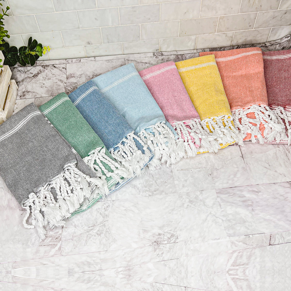 Luxurious oversized Turkish hand towel with bamboo tassels, showcasing vibrant colors and elegant design.