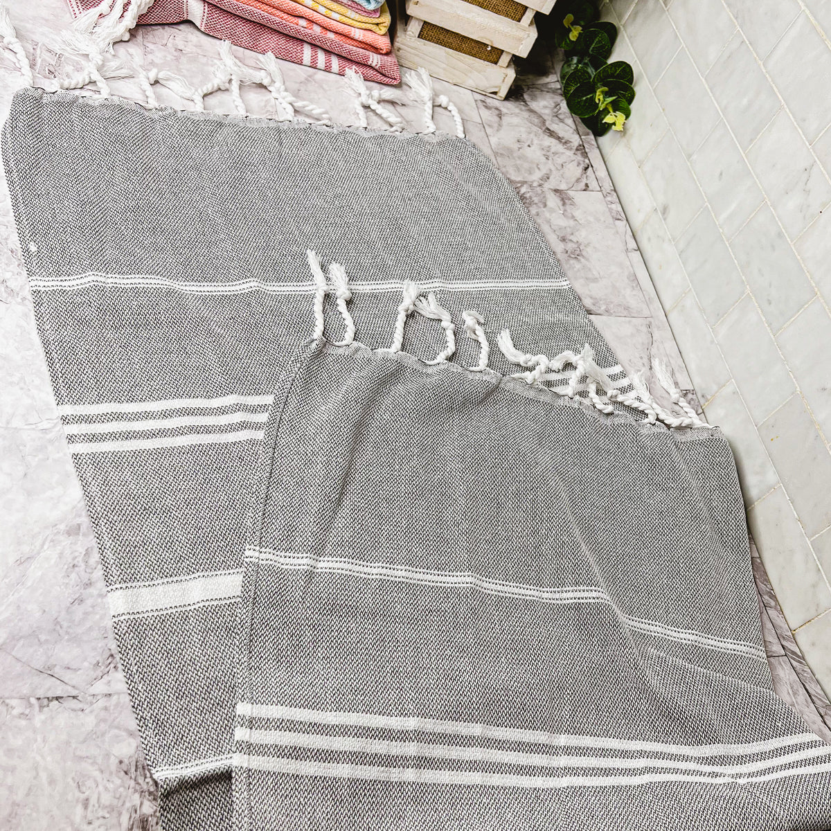 Luxurious oversized Turkish hand towel with bamboo tassels, showcasing vibrant colors and elegant design.