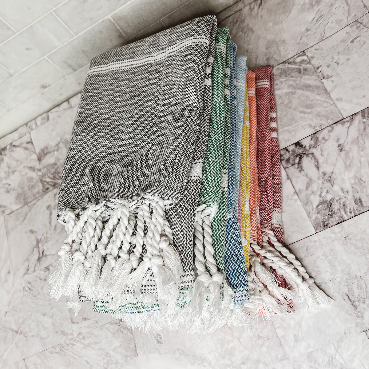 Luxurious oversized Turkish hand towel with bamboo tassels, showcasing vibrant colors and elegant design.