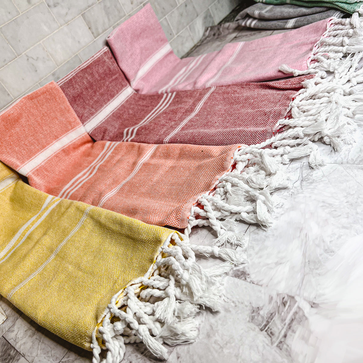 Luxurious oversized Turkish hand towel with bamboo tassels, showcasing vibrant colors and elegant design.