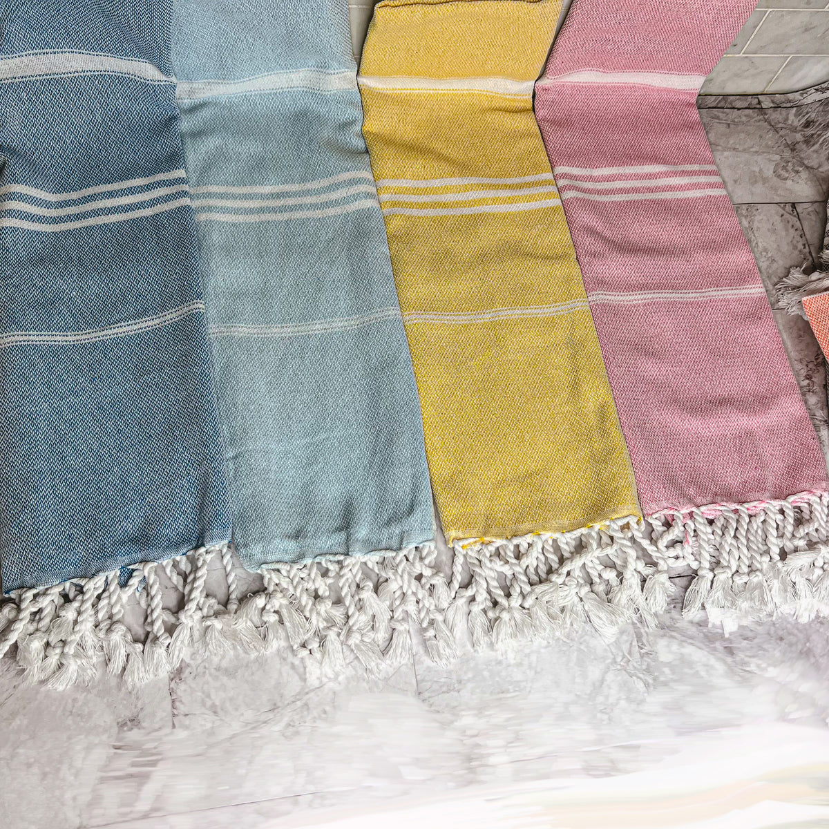 Luxurious oversized Turkish hand towel with bamboo tassels, showcasing vibrant colors and elegant design.