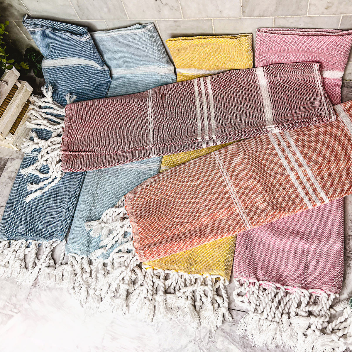 Luxurious oversized Turkish hand towel with bamboo tassels, showcasing vibrant colors and elegant design.