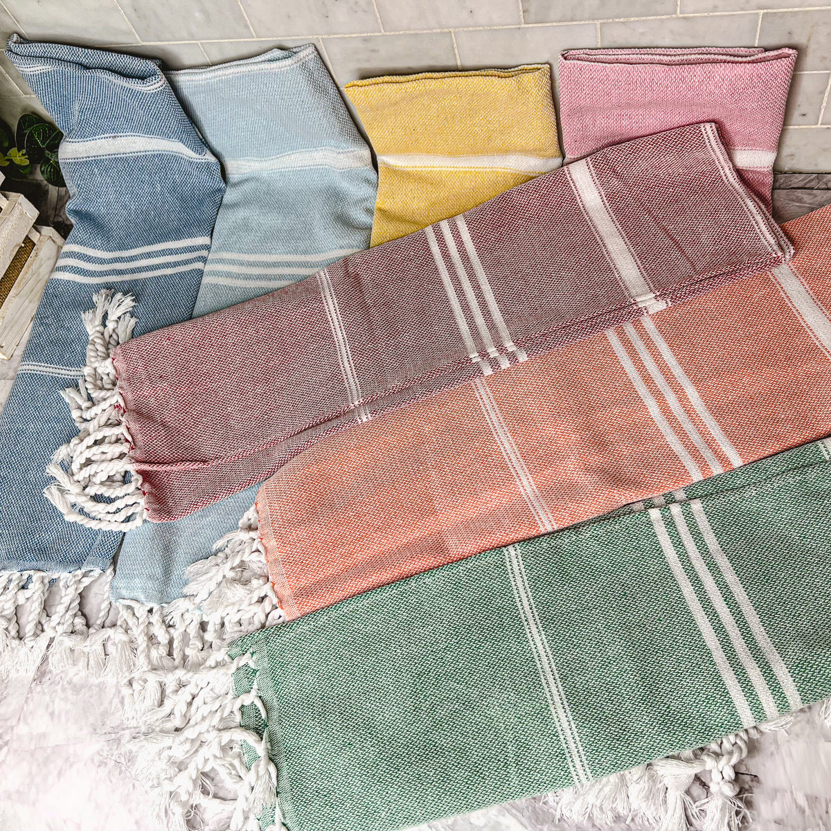 Luxurious oversized Turkish hand towel with bamboo tassels, showcasing vibrant colors and elegant design.