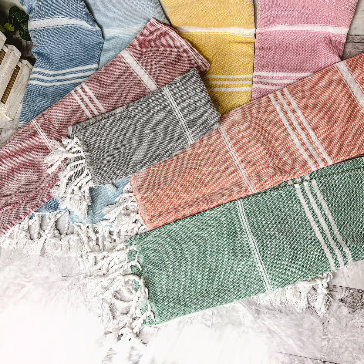 Luxurious oversized Turkish hand towel with bamboo tassels, showcasing vibrant colors and elegant design.