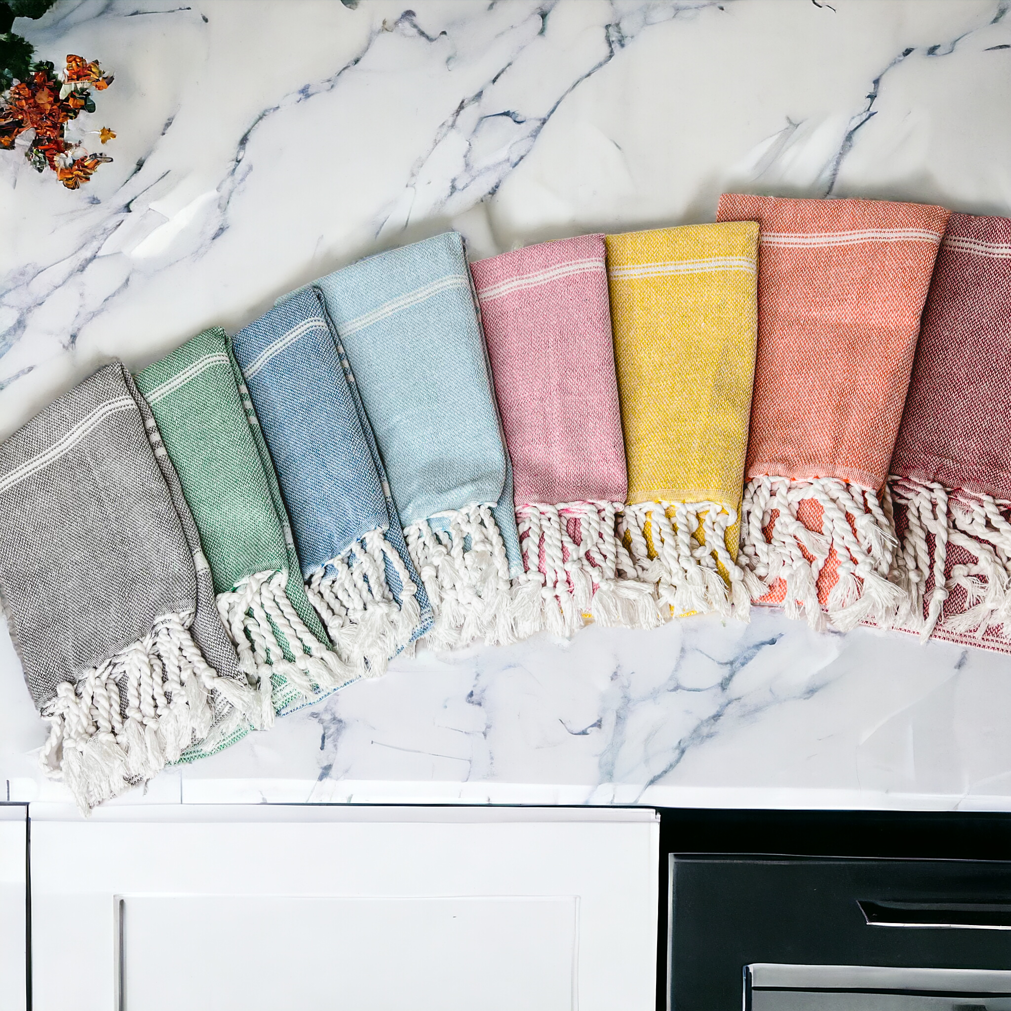 Luxurious oversized Turkish hand towel with bamboo tassels, showcasing vibrant colors and elegant design.