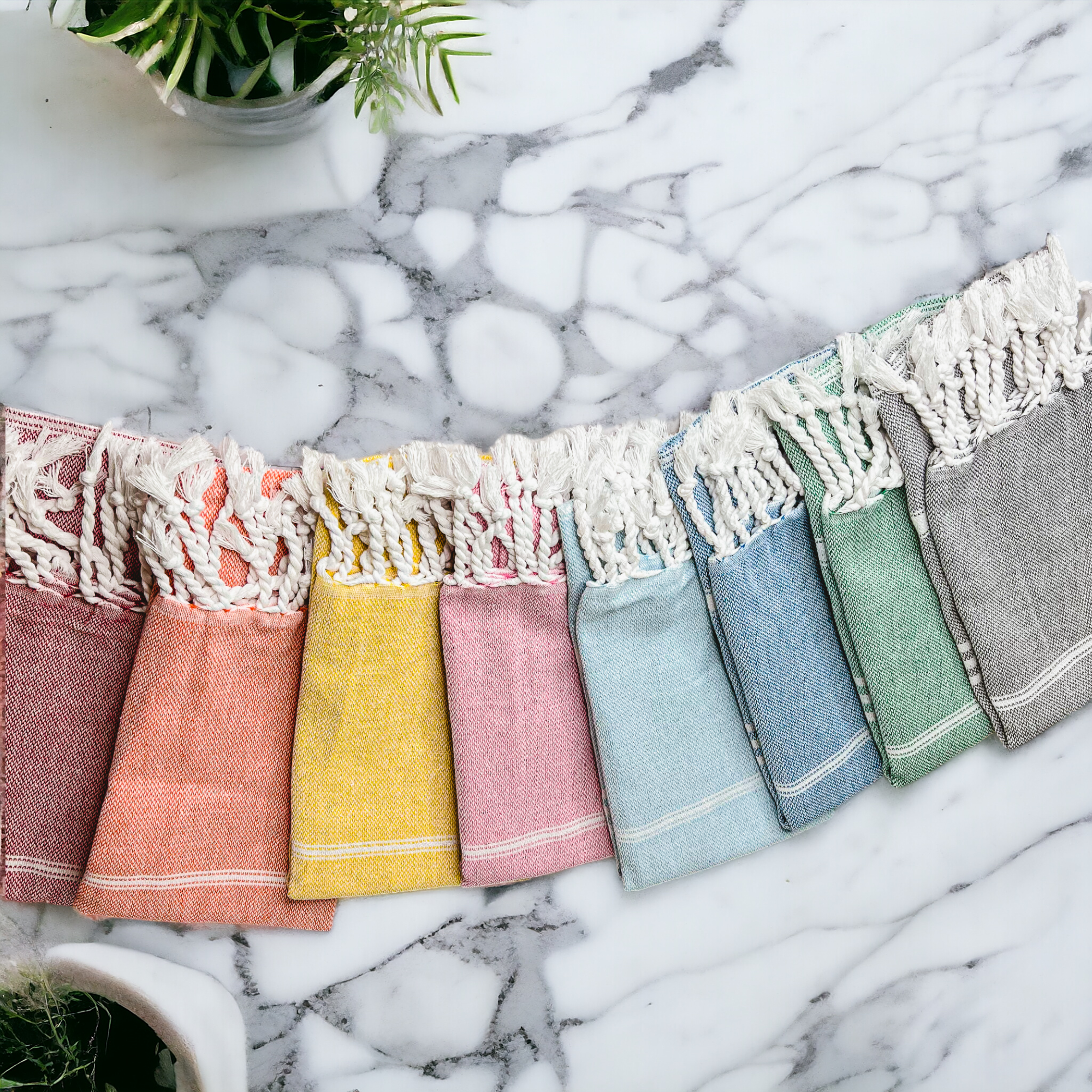 Luxurious oversized Turkish hand towel with bamboo tassels, showcasing vibrant colors and elegant design.
