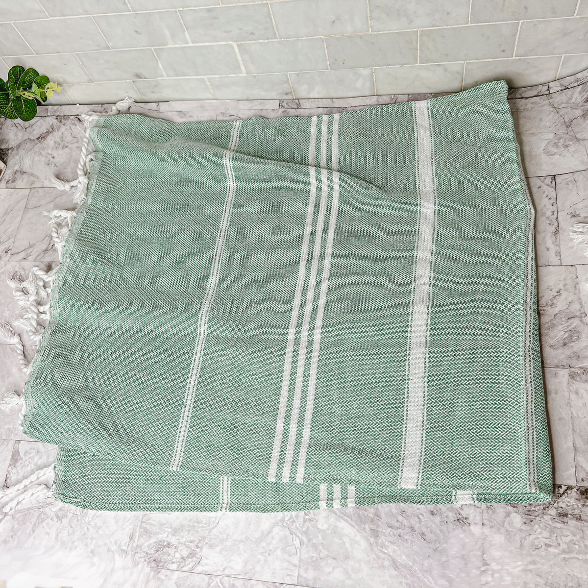 Luxurious oversized Turkish hand towel with bamboo tassels, showcasing vibrant colors and elegant design.