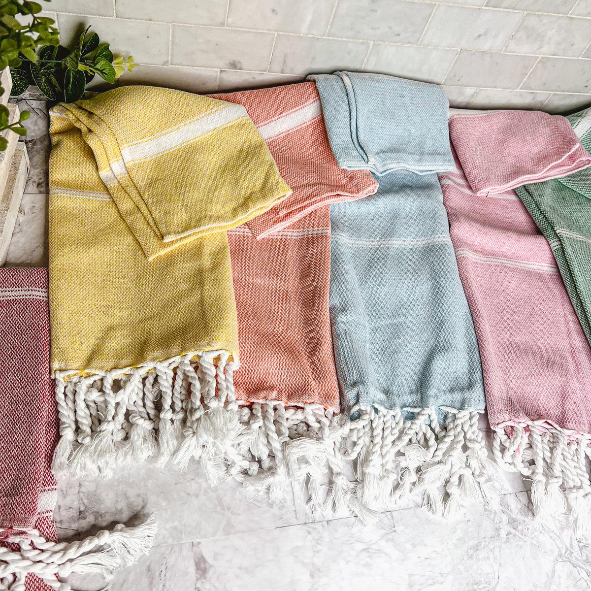 Luxurious oversized Turkish hand towel with bamboo tassels, showcasing vibrant colors and elegant design.