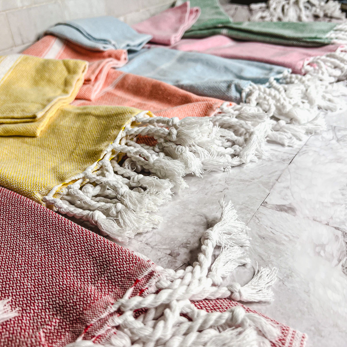 Luxurious oversized Turkish hand towel with bamboo tassels, showcasing vibrant colors and elegant design.