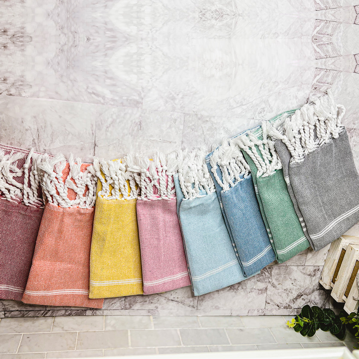 Luxurious oversized Turkish hand towel with bamboo tassels, showcasing vibrant colors and elegant design.