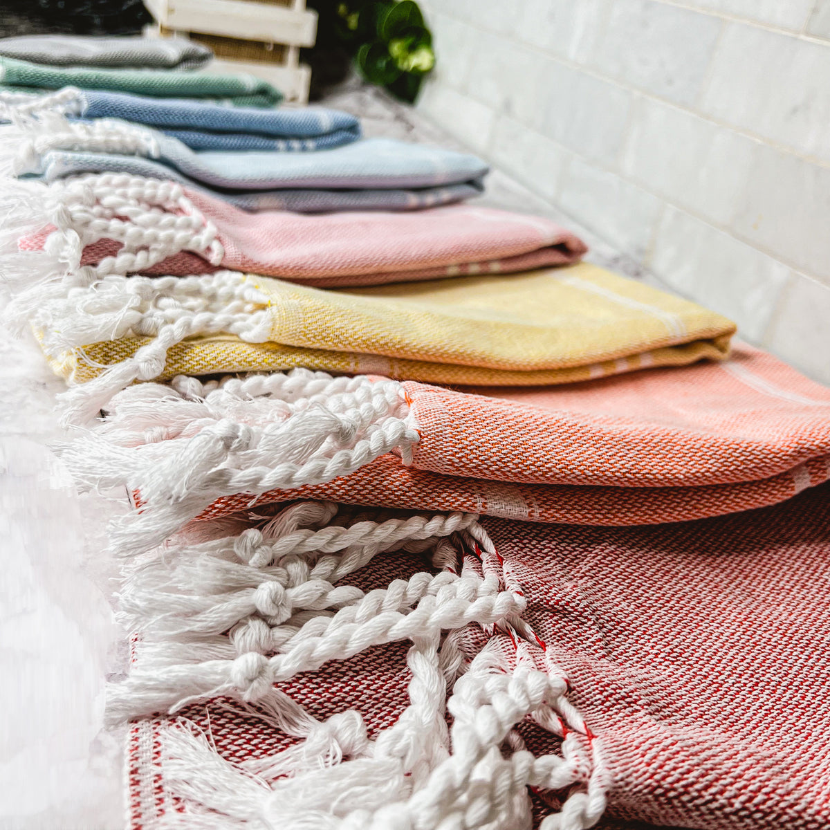 Luxurious oversized Turkish hand towel with bamboo tassels, showcasing vibrant colors and elegant design.