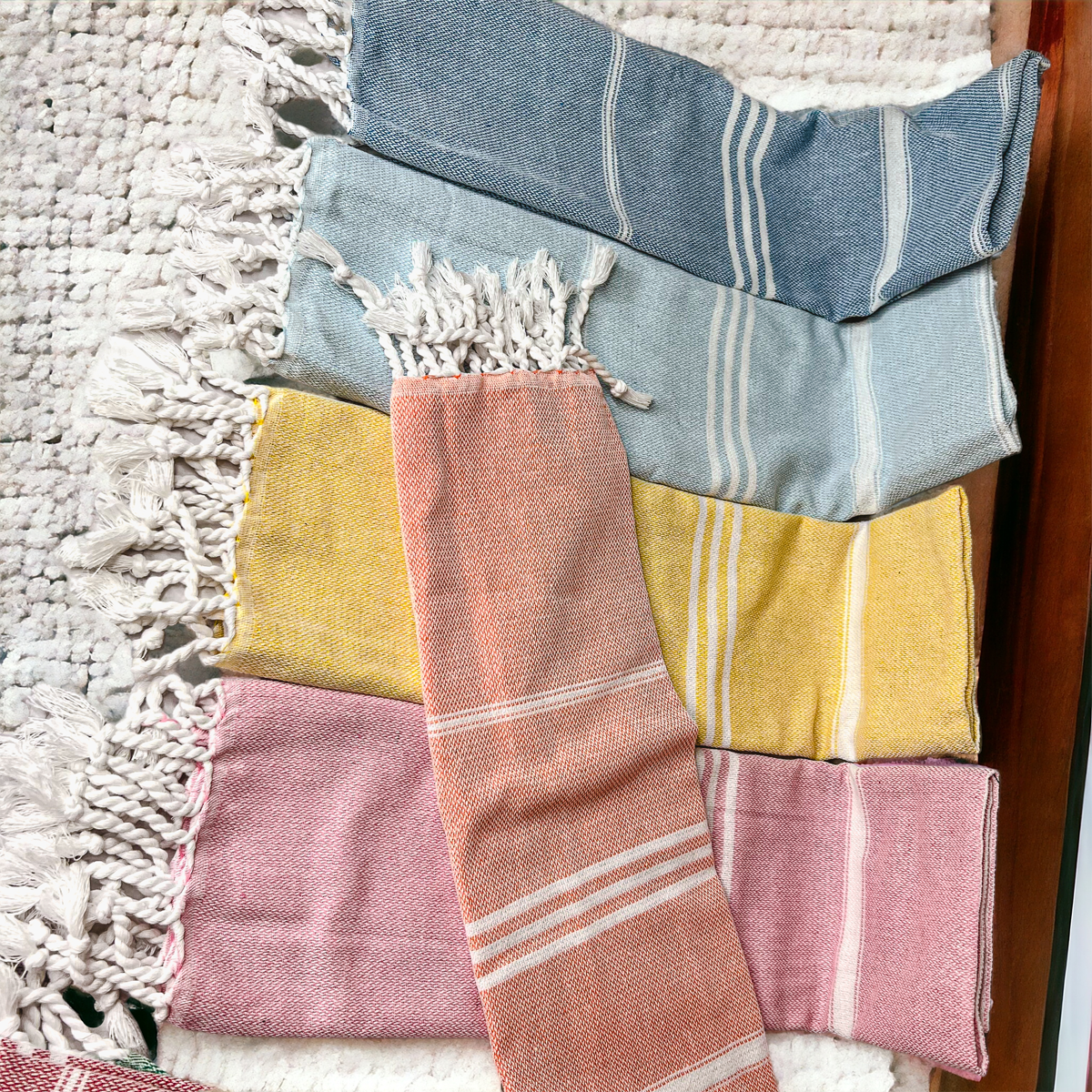 Luxurious oversized Turkish hand towel with bamboo tassels, showcasing vibrant colors and elegant design.