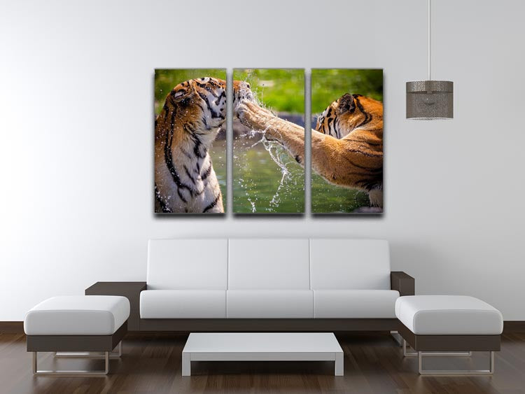Three-panel canvas print featuring two adult tigers playing in water, showcasing vibrant colors and intricate details.