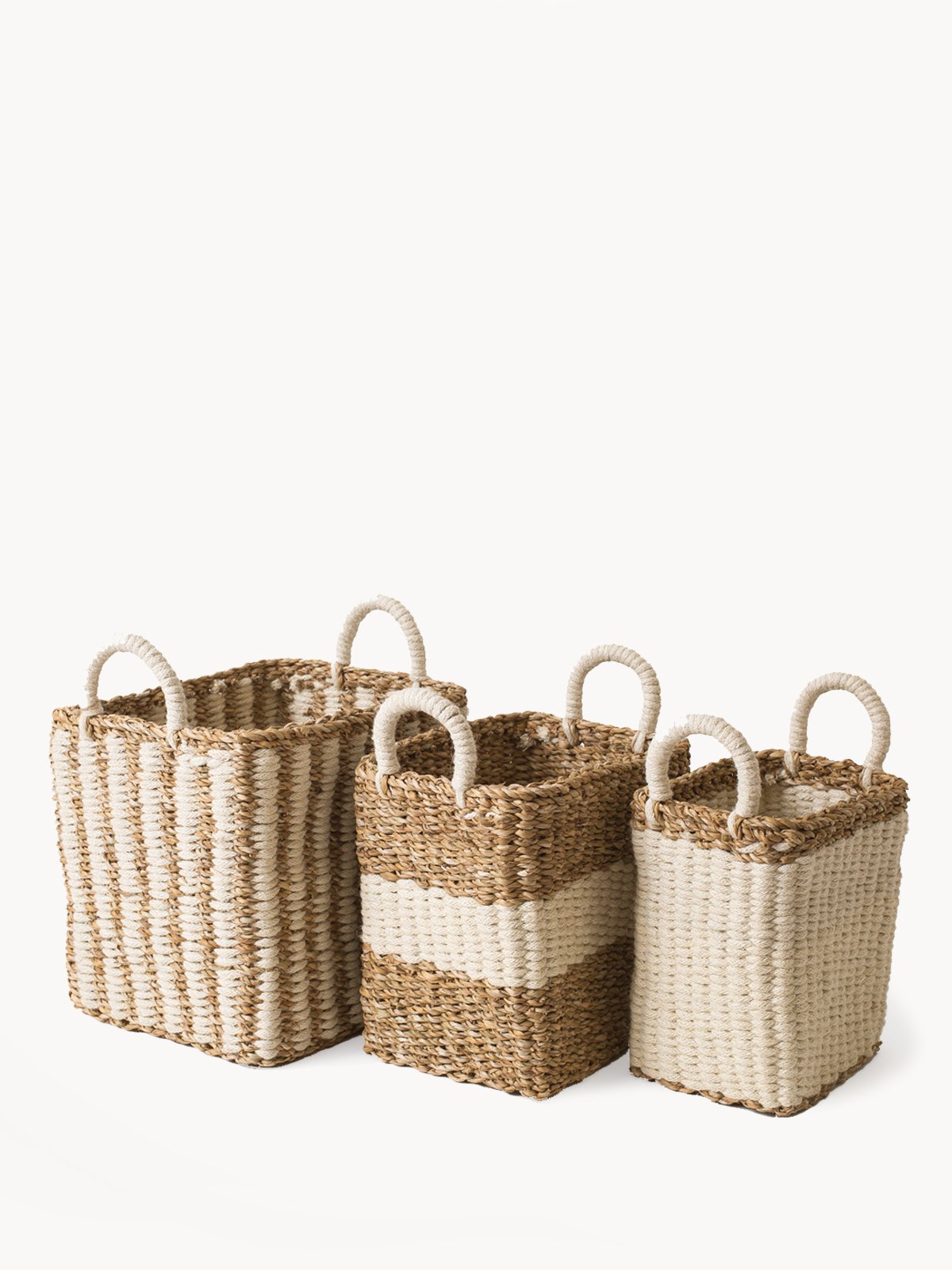 Ula Storage Basket made from seagrass and jute, showcasing its natural and white color, perfect for home organization.