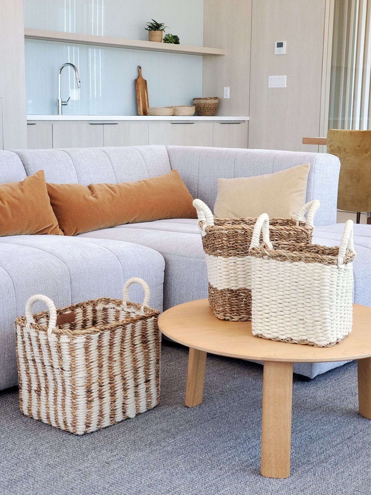 Ula Storage Basket made from seagrass and jute, showcasing its natural and white color, perfect for home organization.