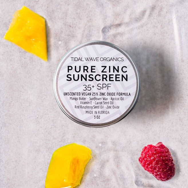 Vegan Pure Zinc Mineral Sunscreen in a metal container, showcasing its creamy texture and natural ingredients.