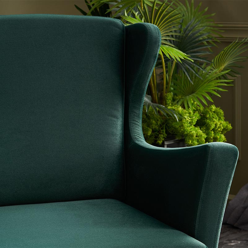Velvet Armchair LORD in Dark Green, showcasing plush upholstery and elegant design with natural beech wood legs.