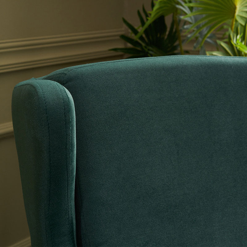 Velvet Armchair LORD in Dark Green, showcasing plush upholstery and elegant design with natural beech wood legs.