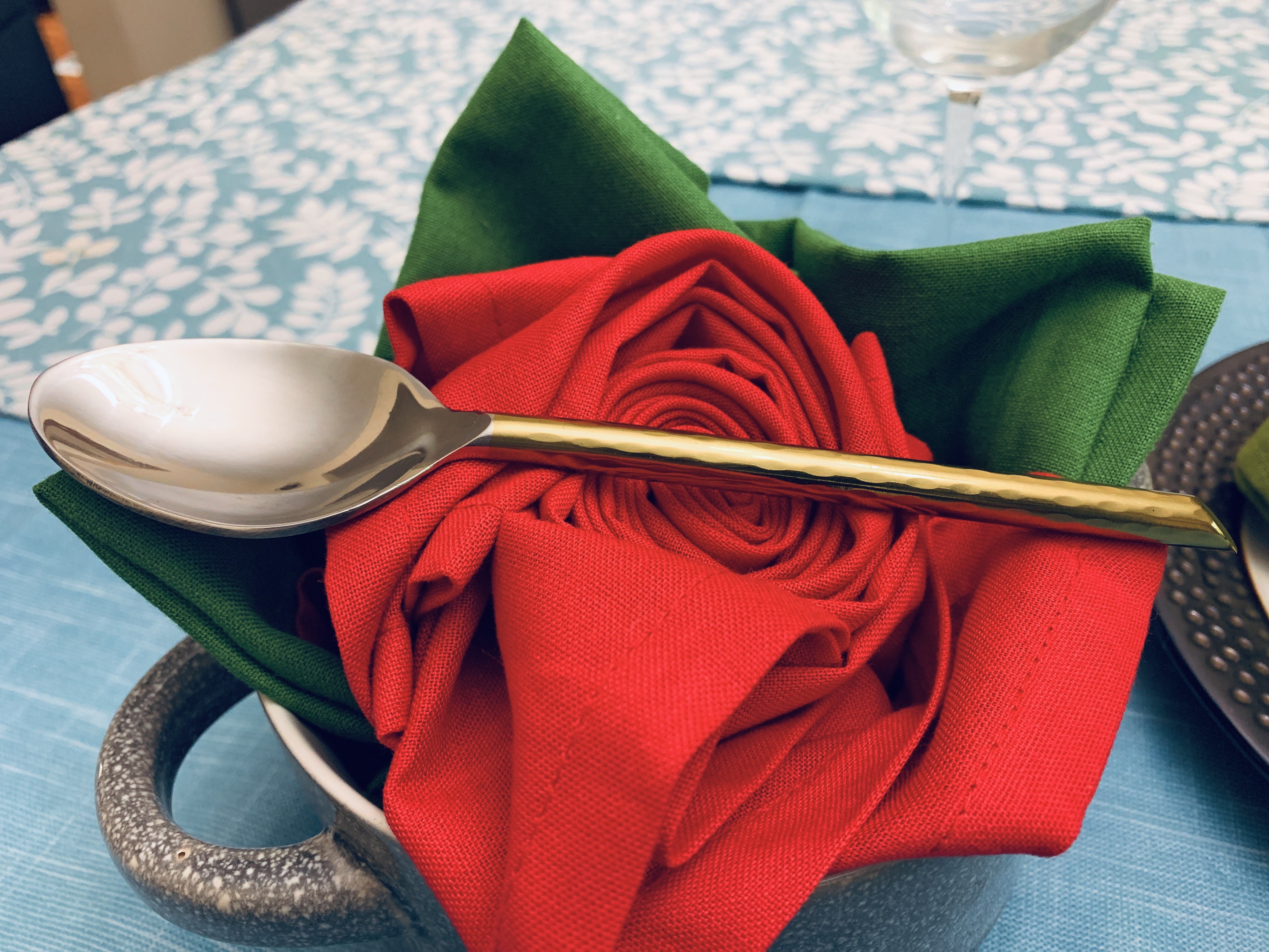 Vibhsa Stainless Steel Gold Flatware set of 20 pieces displayed elegantly on a dining table, showcasing its luxurious design and polished finish.