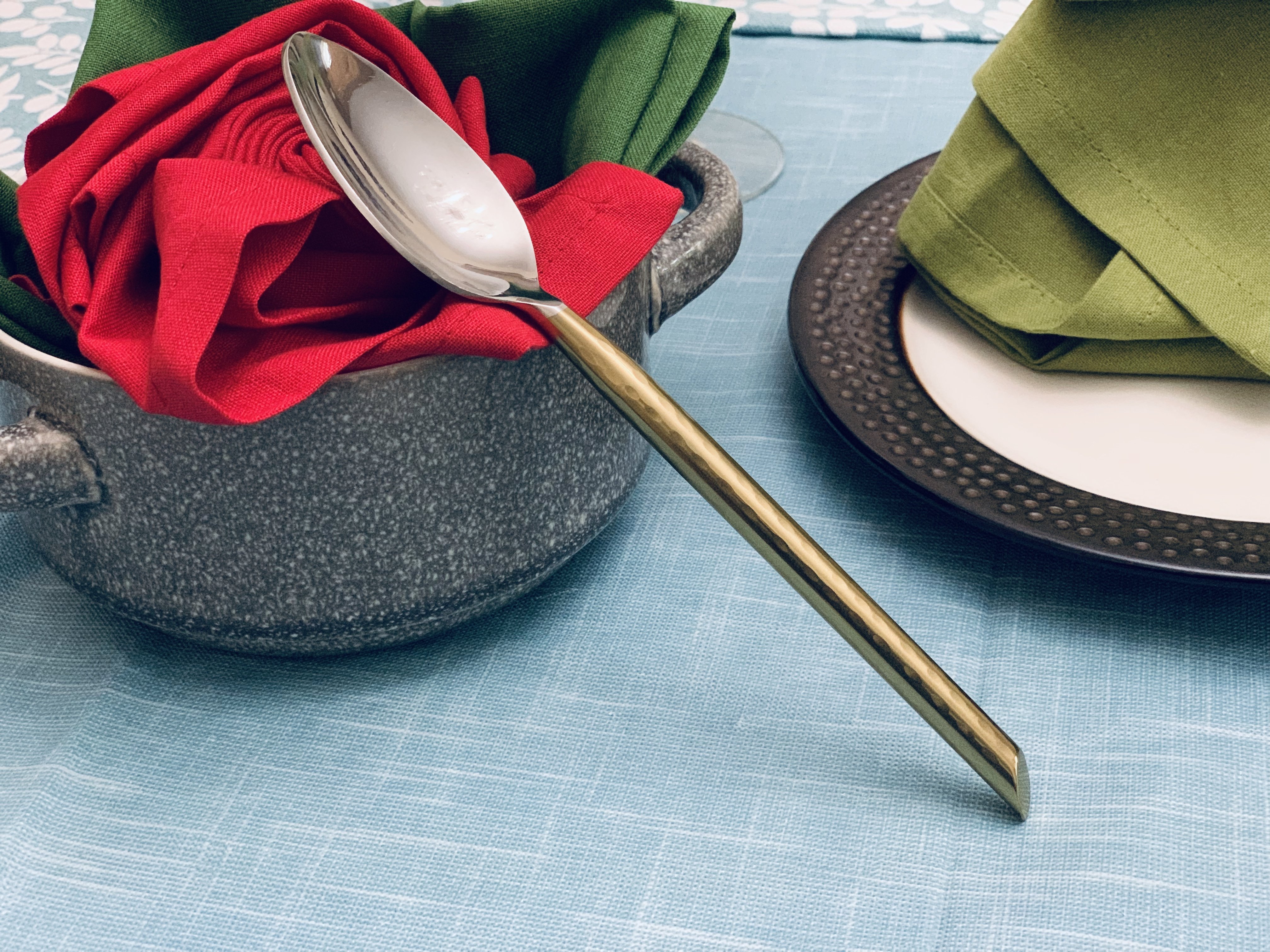 Vibhsa Stainless Steel Gold Flatware set of 20 pieces displayed elegantly on a dining table, showcasing its luxurious design and polished finish.