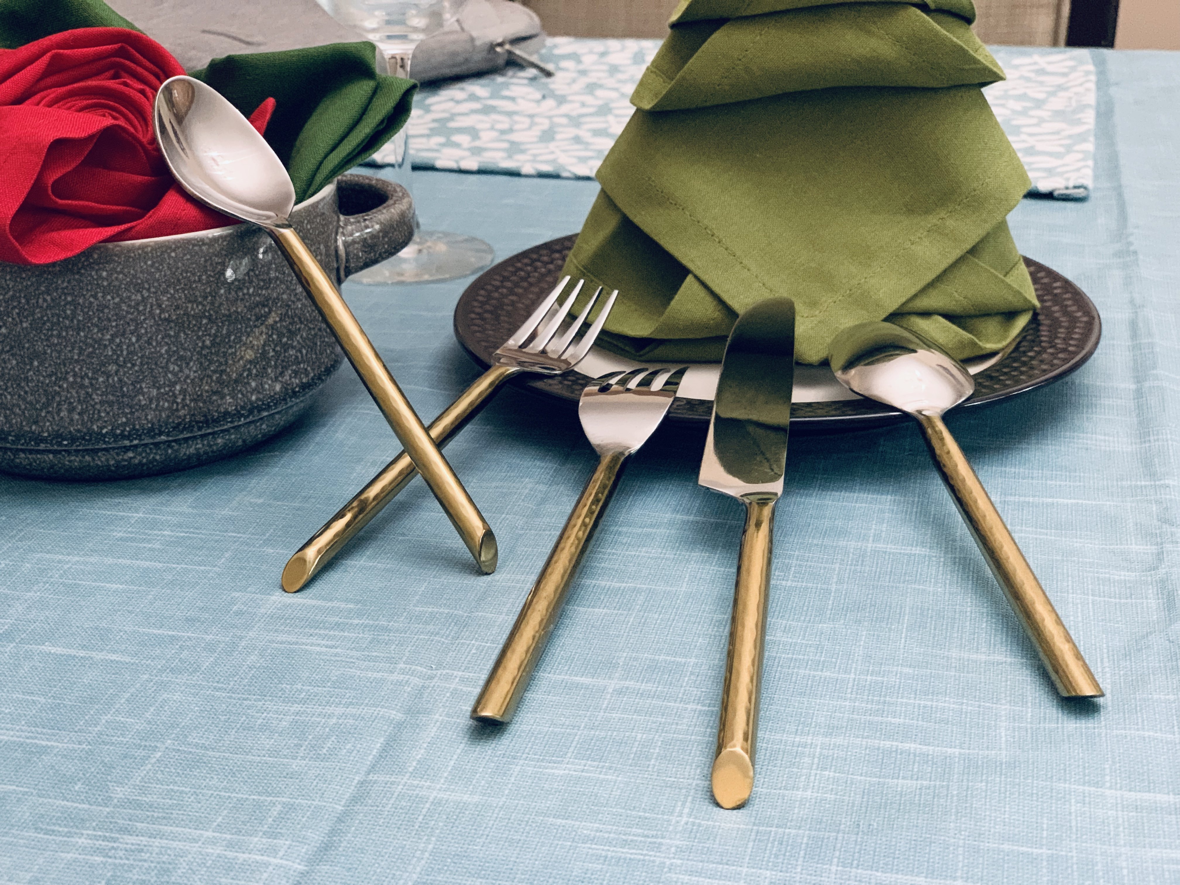 Vibhsa Stainless Steel Gold Flatware set of 20 pieces displayed elegantly on a dining table, showcasing its luxurious design and polished finish.