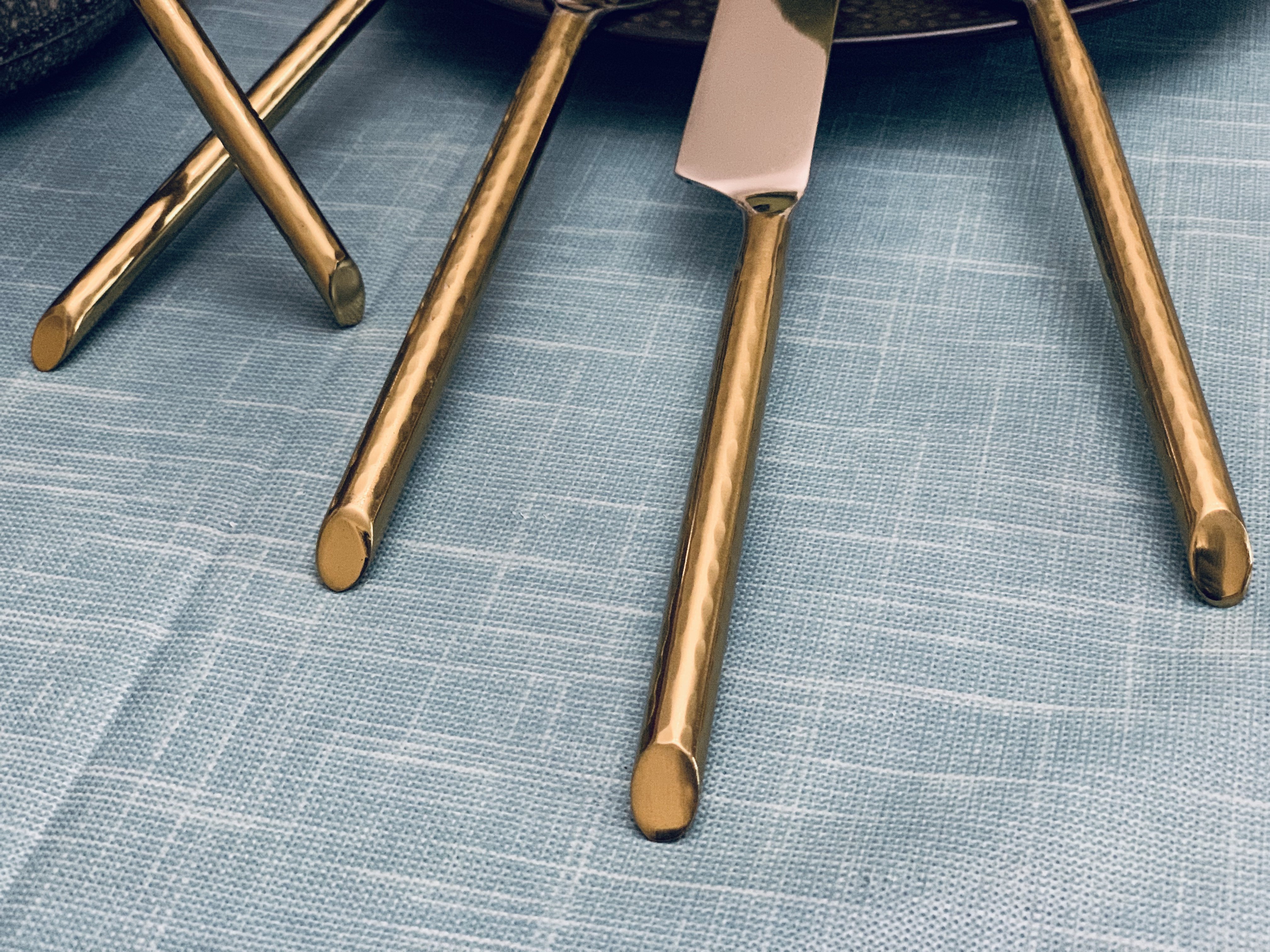 Vibhsa Stainless Steel Gold Flatware set of 20 pieces displayed elegantly on a dining table, showcasing its luxurious design and polished finish.