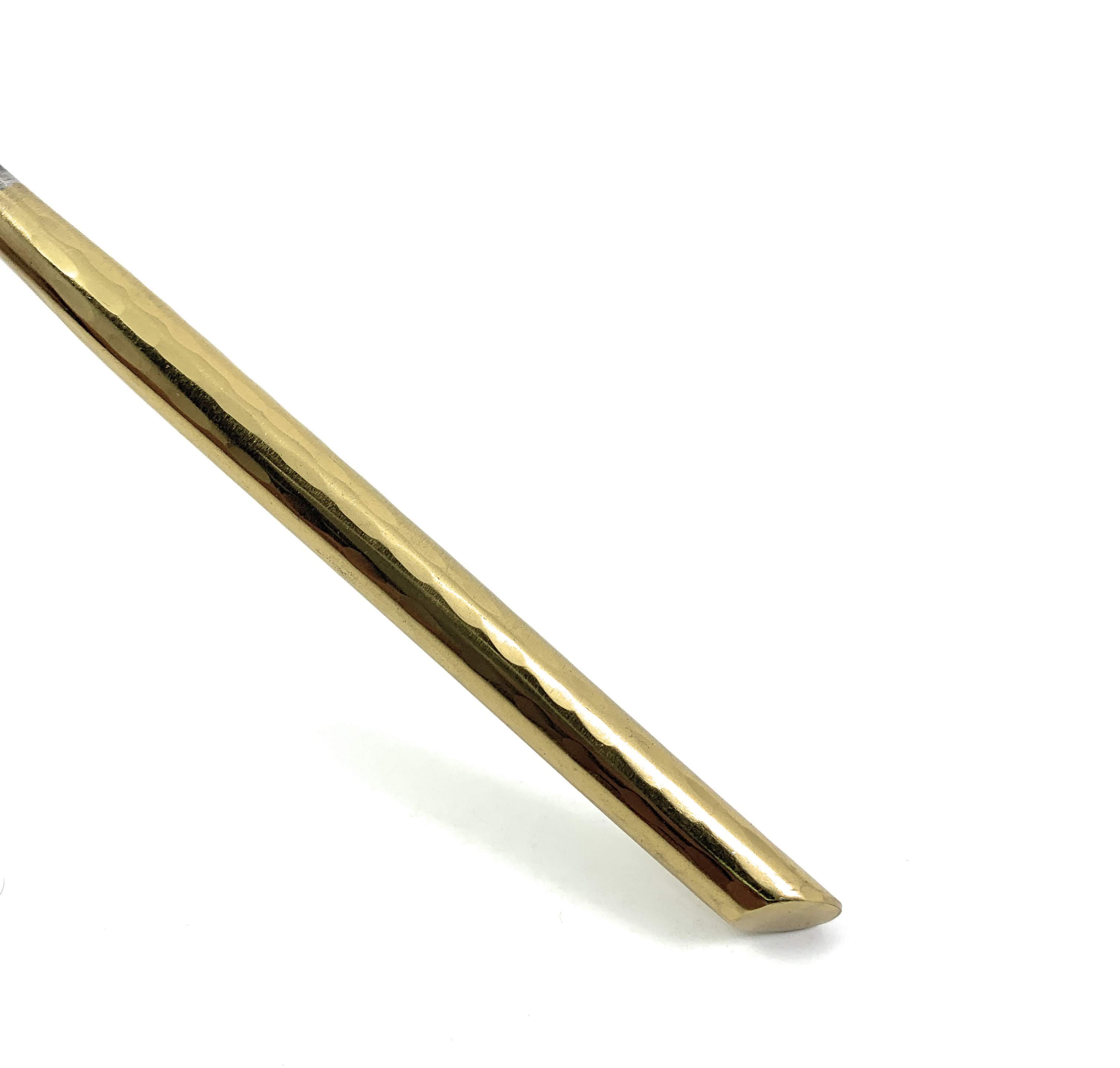 Vibhsa Stainless Steel Gold Flatware set of 20 pieces displayed elegantly on a dining table, showcasing its luxurious design and polished finish.