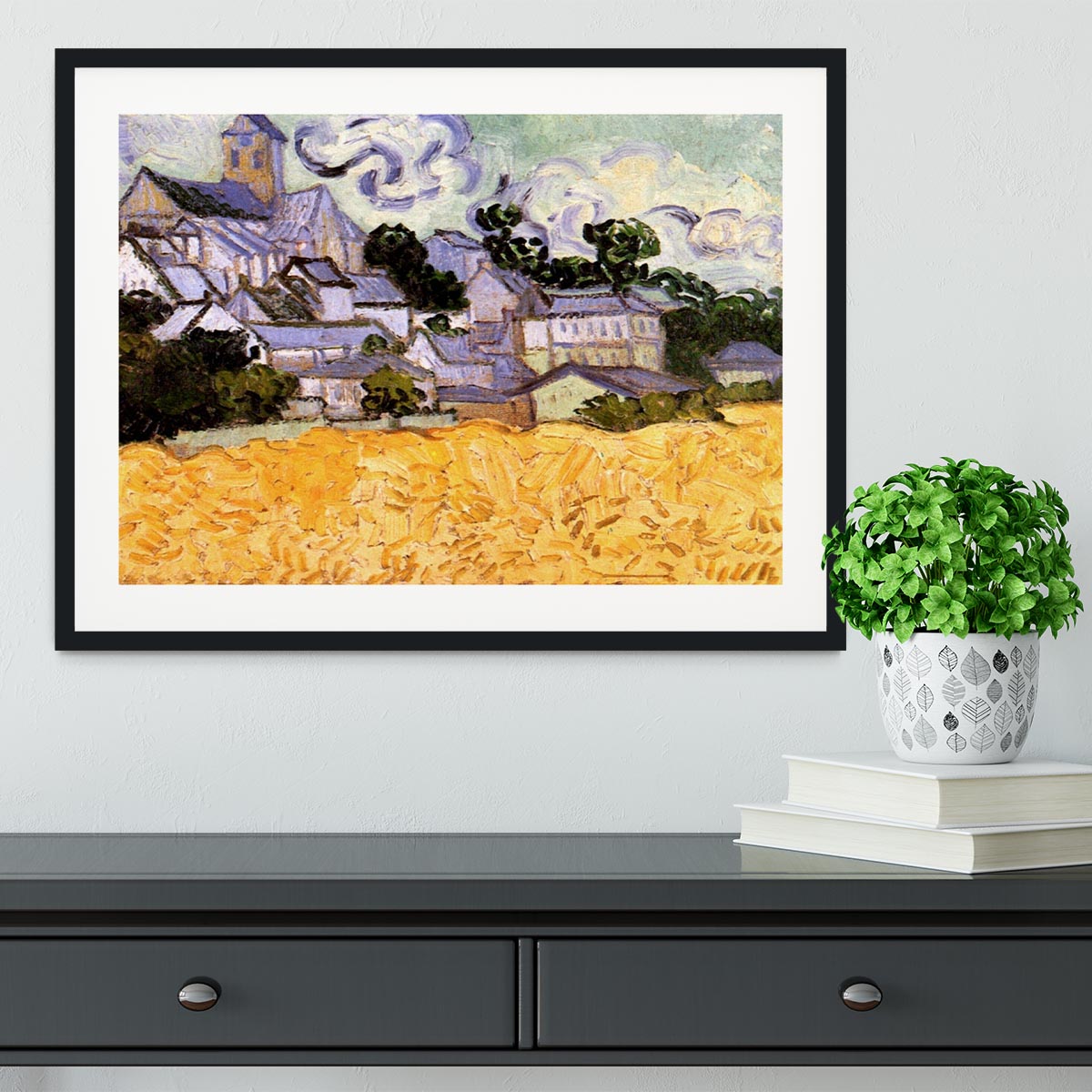 Framed print of Van Gogh's View of Auvers with Church, showcasing vibrant colors and intricate details in a handmade frame.