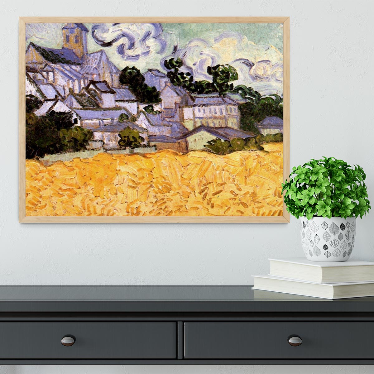Framed print of Van Gogh's View of Auvers with Church, showcasing vibrant colors and intricate details in a handmade frame.