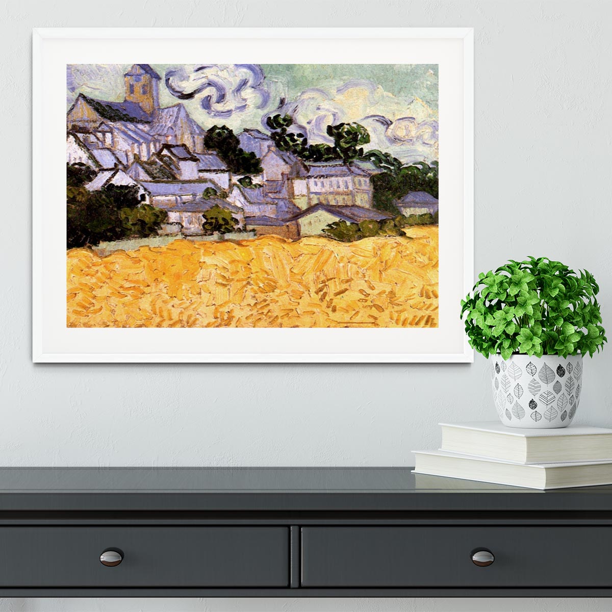 Framed print of Van Gogh's View of Auvers with Church, showcasing vibrant colors and intricate details in a handmade frame.