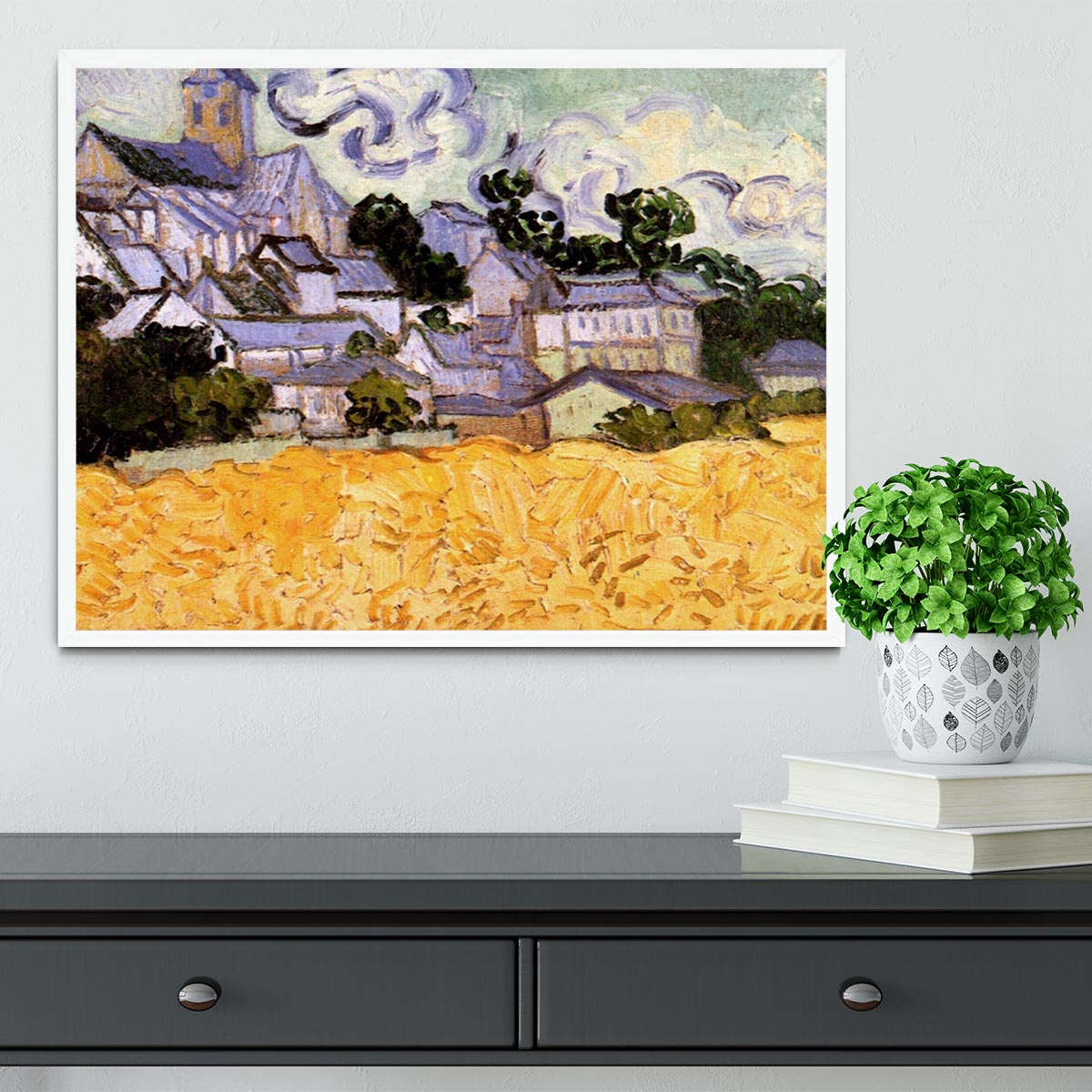 Framed print of Van Gogh's View of Auvers with Church, showcasing vibrant colors and intricate details in a handmade frame.