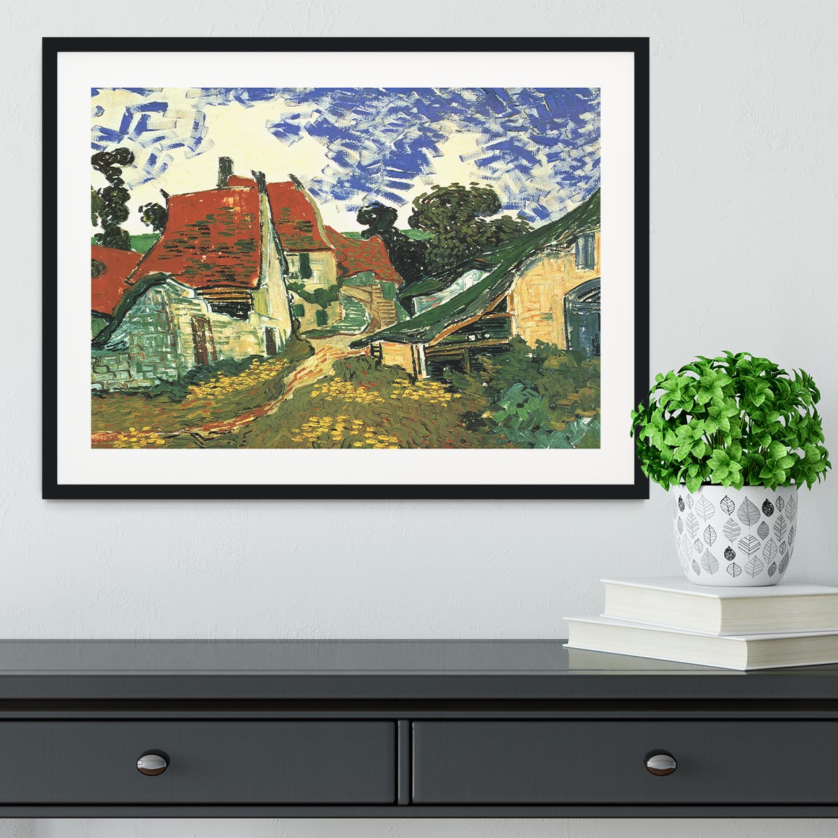 Framed print of Van Gogh's Villages Street in Auvers, showcasing vibrant colors and intricate details in a stylish frame.