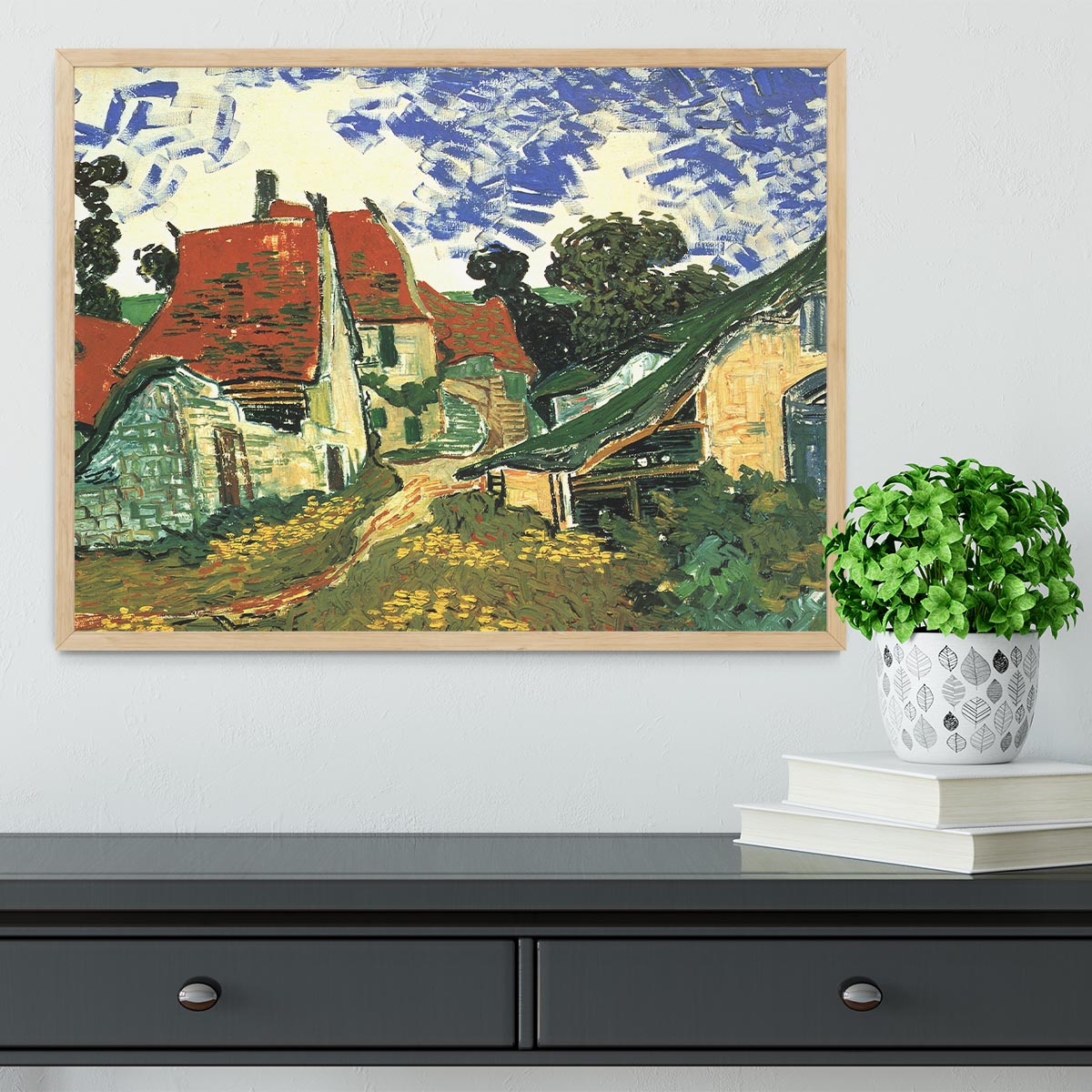 Framed print of Van Gogh's Villages Street in Auvers, showcasing vibrant colors and intricate details in a stylish frame.