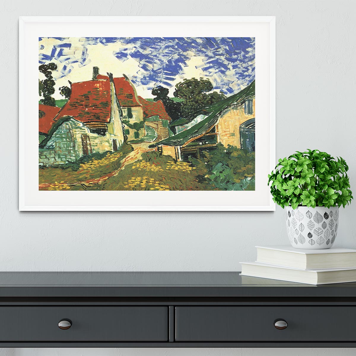 Framed print of Van Gogh's Villages Street in Auvers, showcasing vibrant colors and intricate details in a stylish frame.