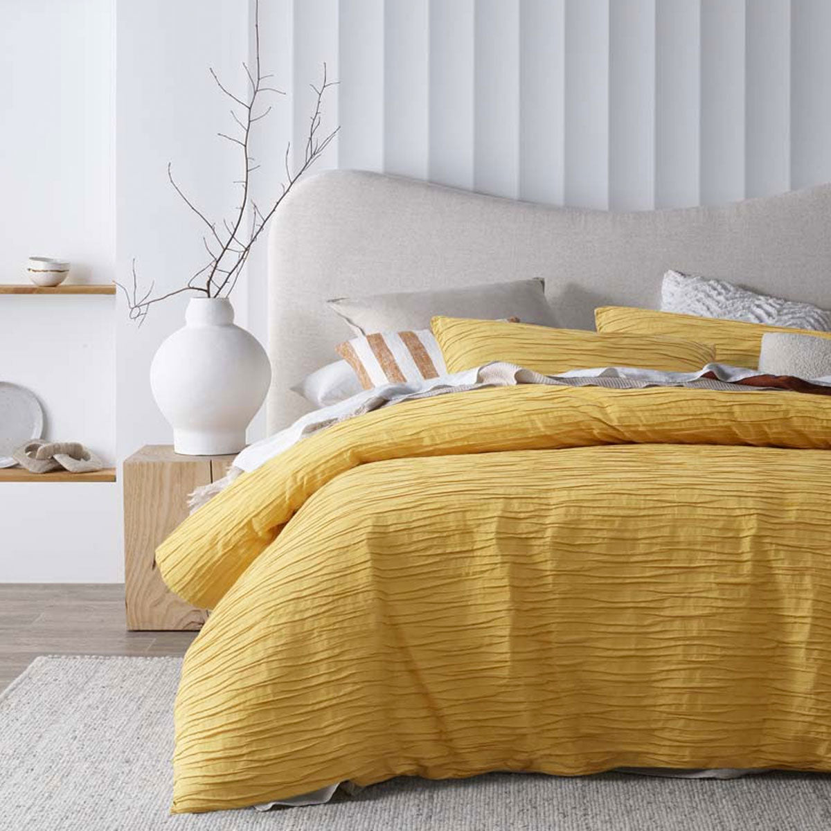 Malvern Ochre Cotton Quilt Cover Set featuring horizontal pleats, perfect for a chic bedroom decor.